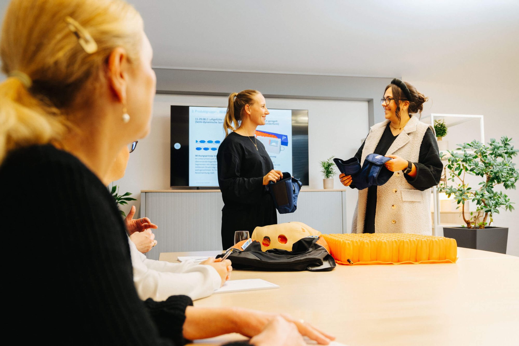 Carenetic employees presenting anti-decubitus seat cushions and alternating pressure overlays during a training session