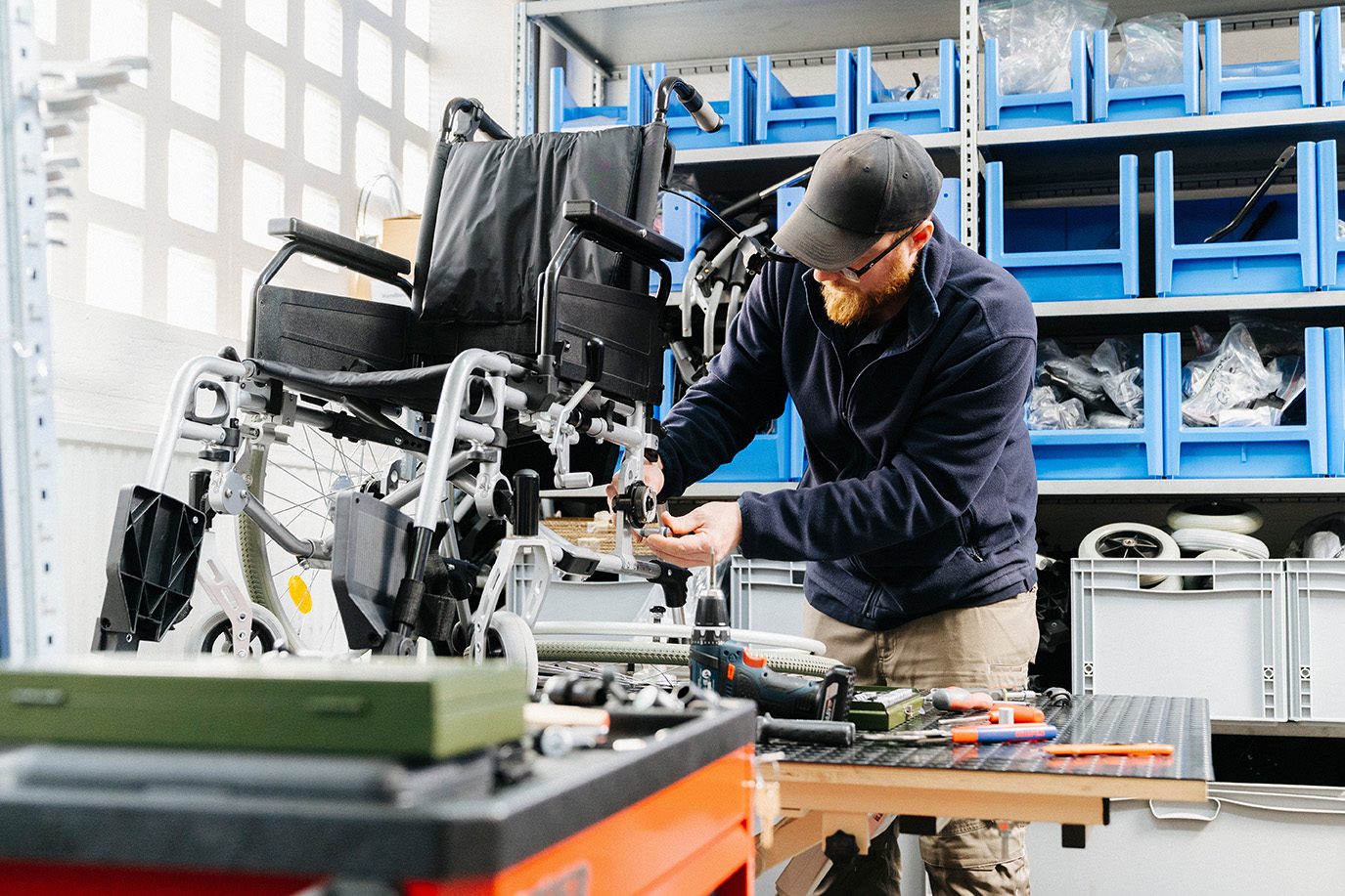 Carenetic technician repairing a wheelchair in the workshop