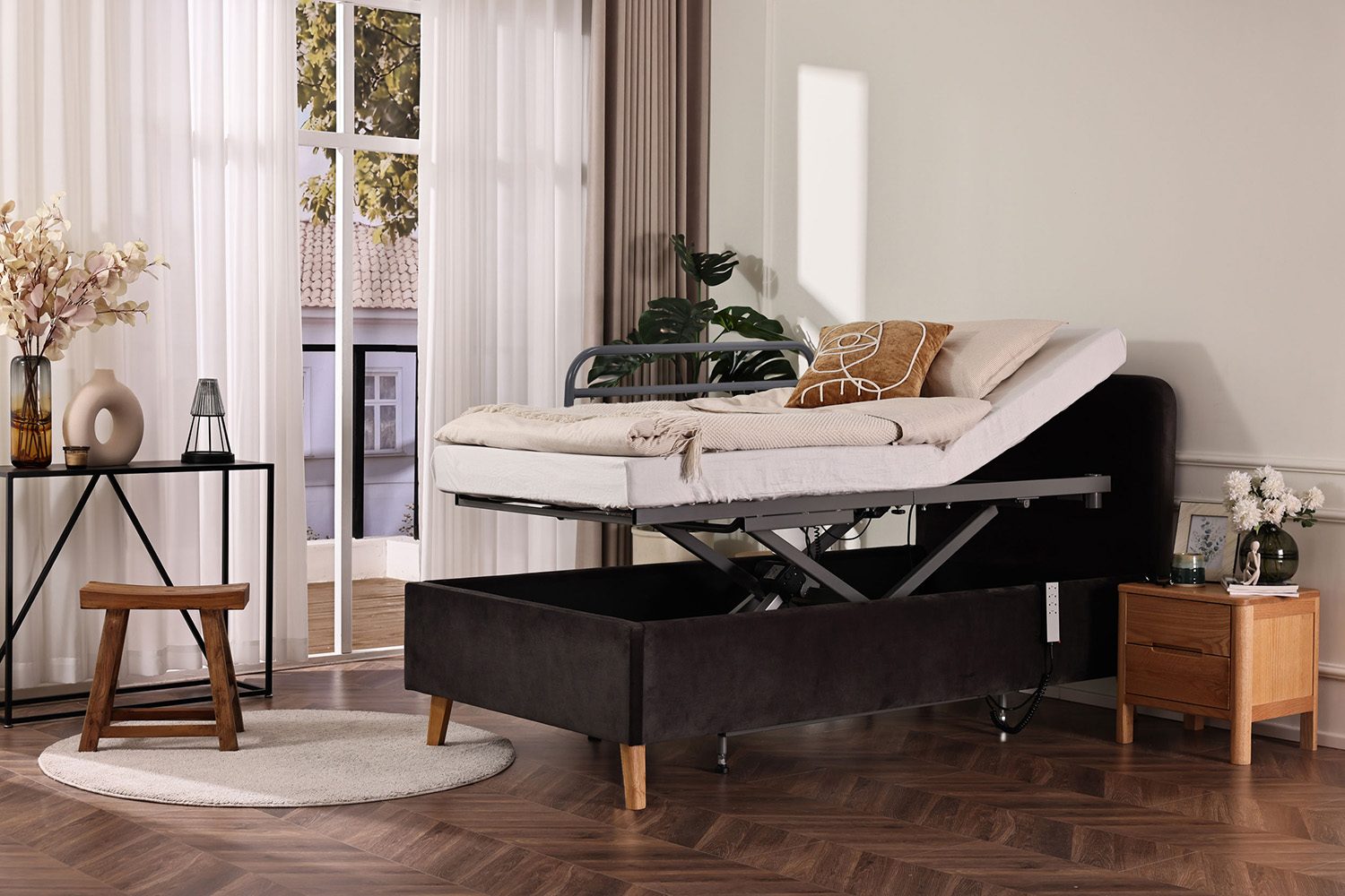 Height-adjustable care bed with raised head section in a living room